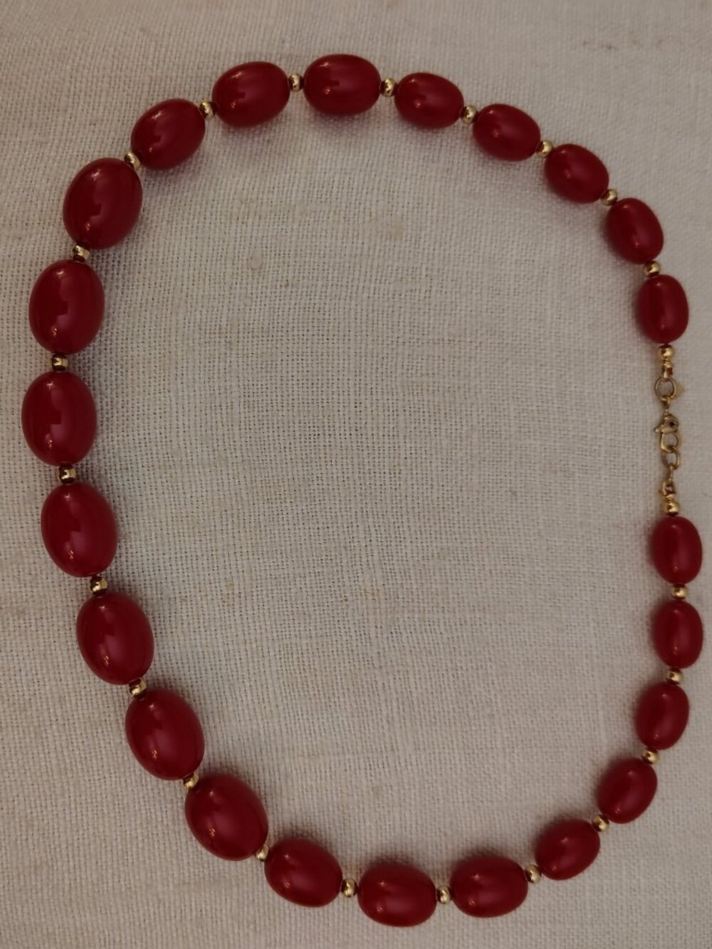 Monet: Red beaded Necklace with tiny gold tone accent beads.